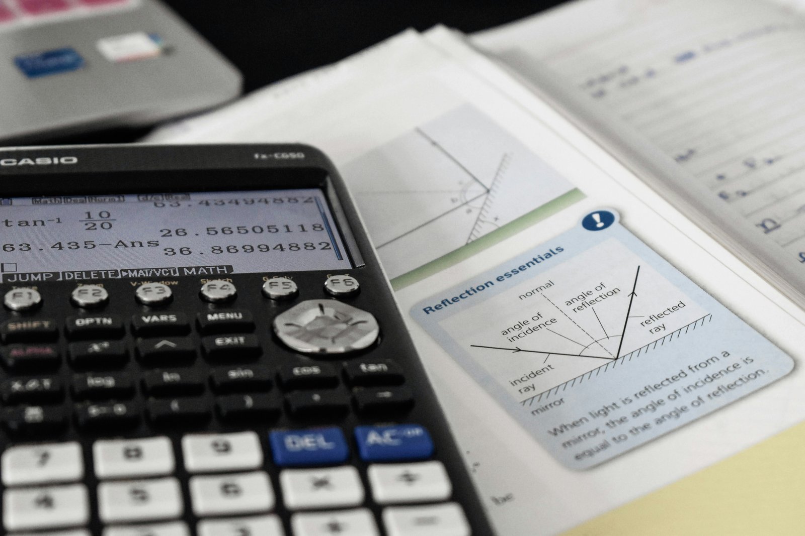 Academic tutoring preparation — calculator on textbook